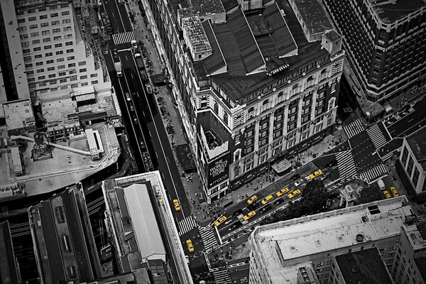 New York in a black-and-white photo with yellow taxi cars