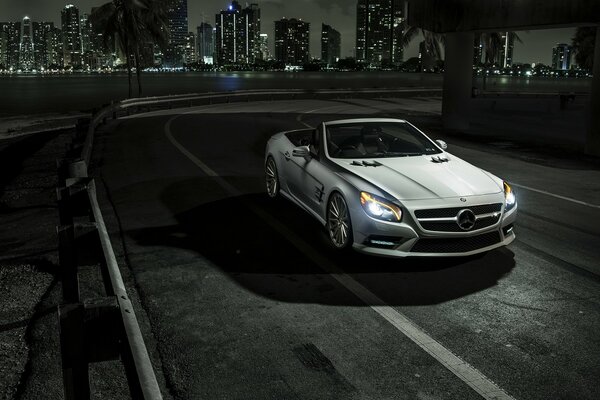 Night city and Mercedes car on a gray background