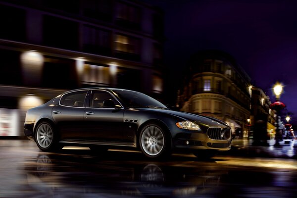 Black Maserati car on the background of the night city