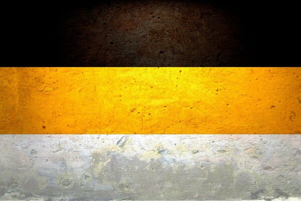 Flaga Imperium Rosyjskiego. Czarno-żółto-biały kolor na ścianie