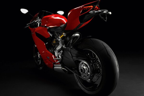 Red sports motorcycle on a black background