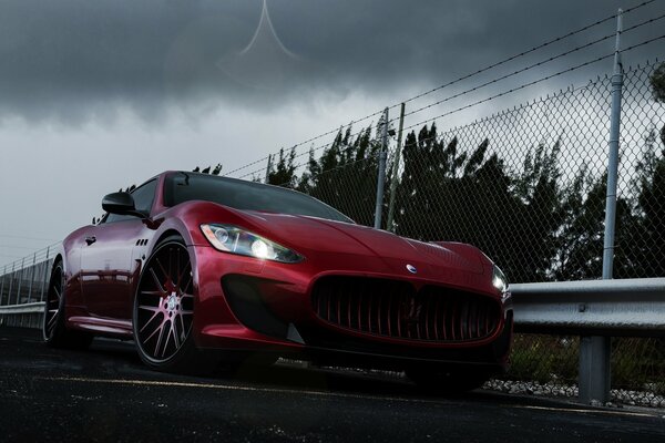 Tuned car Maserati granturismo on the background of cloudy weather