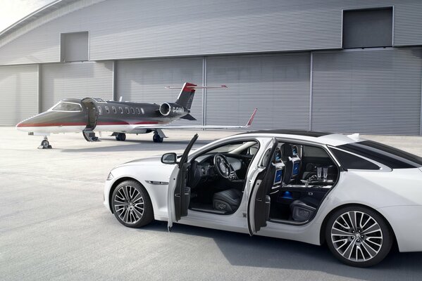 White jaguar on the background of an airplane with open doors