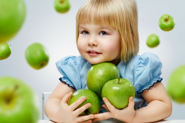 Little girl model with green apples