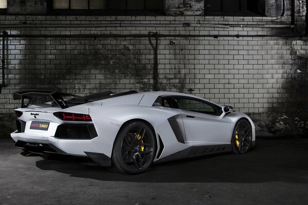 White tuning lamborghini sports car on the background of the wall