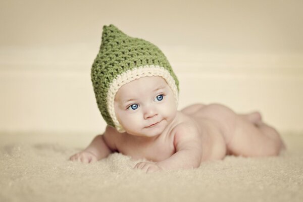 The child s green hat. Uplifts the mood