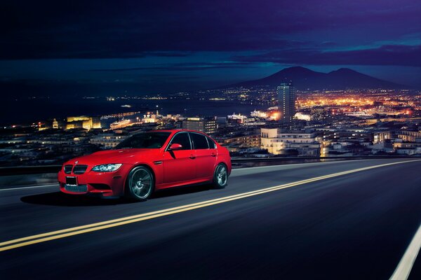 Red BMW on a city background