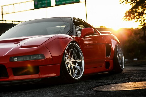 Red honda supercar on big wheels