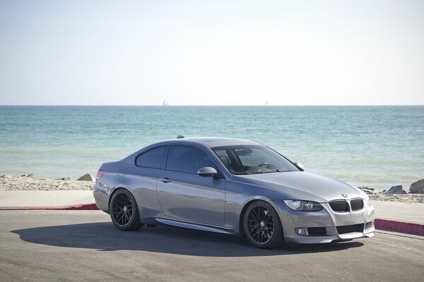 Grey BMW 335i Coupe Shade beach sea