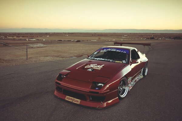 Mazda rx7 in the middle of a deserted road