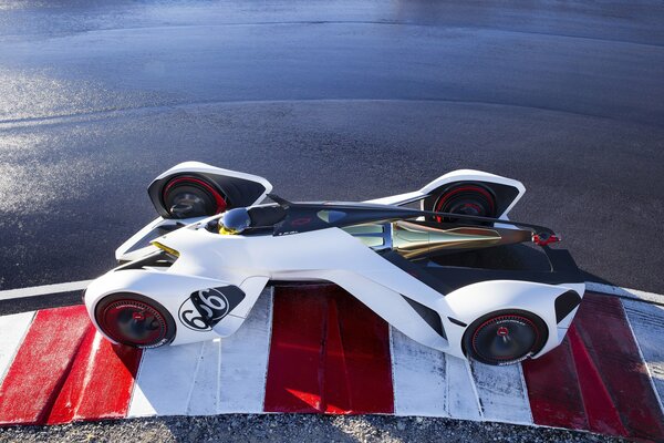 A racing car on a red and white road