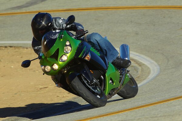 Green motorcycle in a turn on the track
