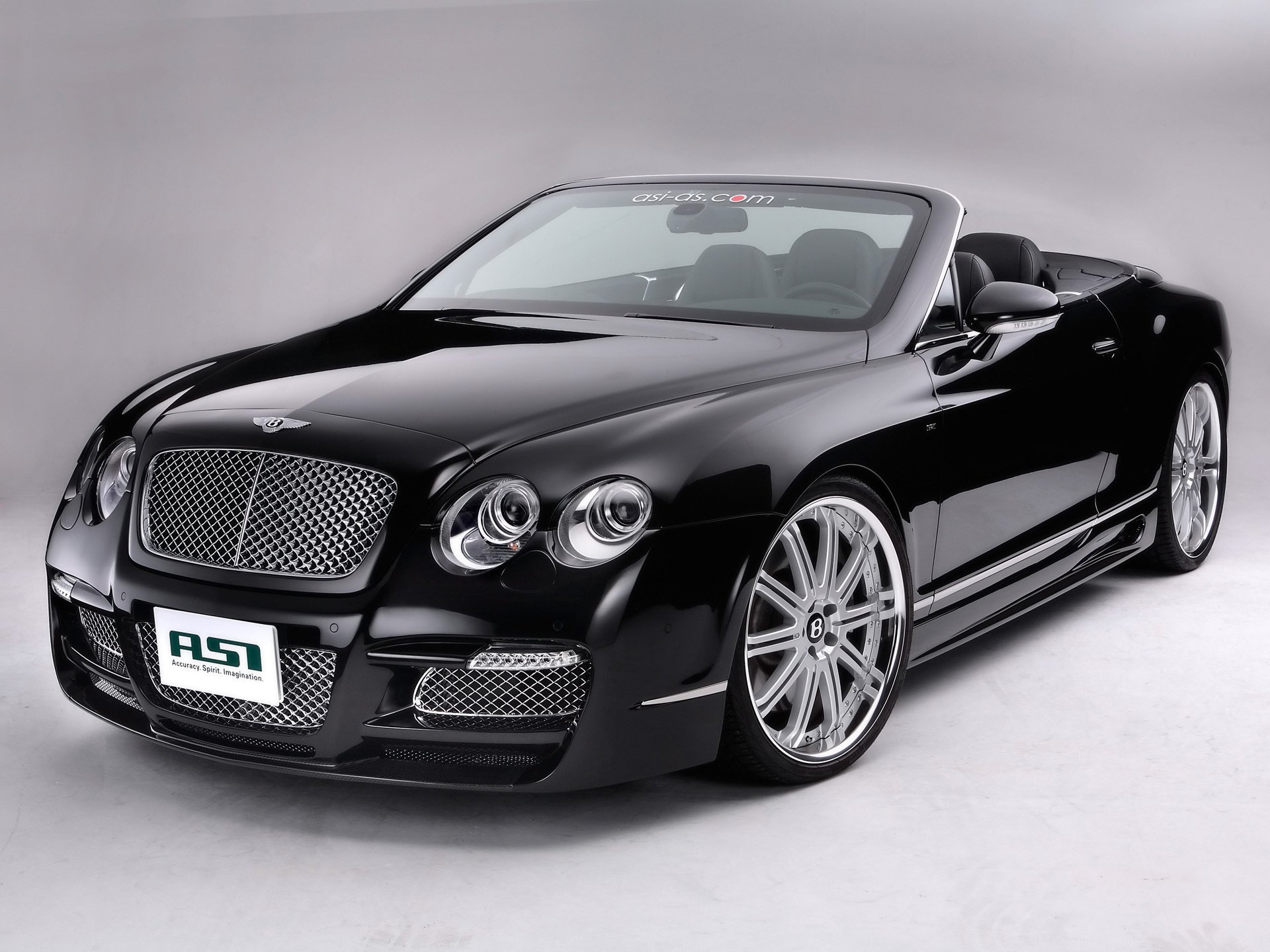 machine bentley convertible black drives on a gray background