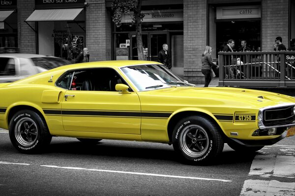 Yellow classic Ford Mustang on the road