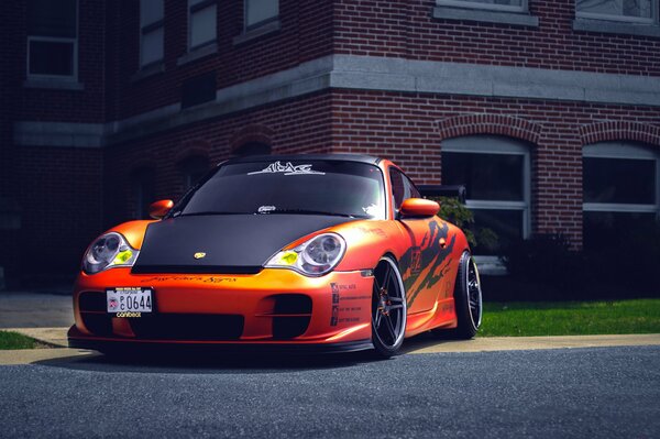 Orange Porsche with black and charcoal hood