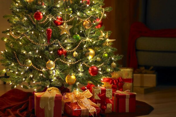 Gifts under the Christmas tree in red and gold