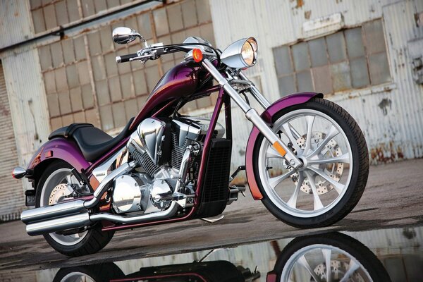 A beautiful powerful motorcycle near a puddle