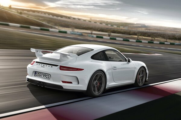 Porsche on the race track in the rays of the Sun