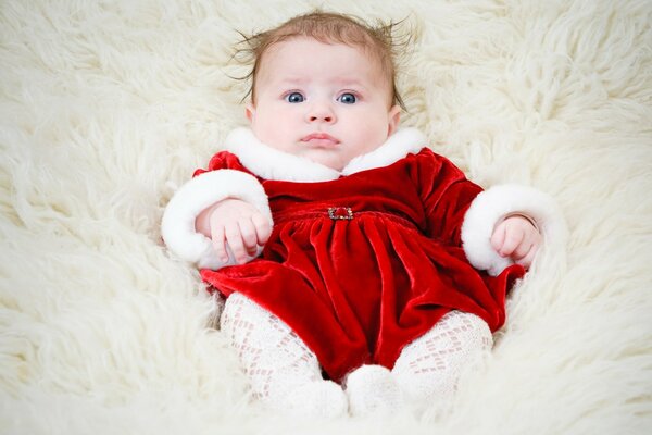 A charming child is lying in furs