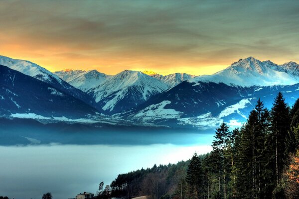 Snowy mountains and the sky in the blue expanse of the lake