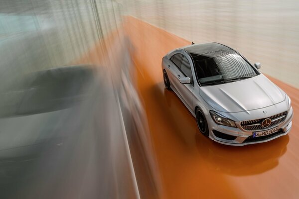 View of a silver Mercedes-Benz from above in motion