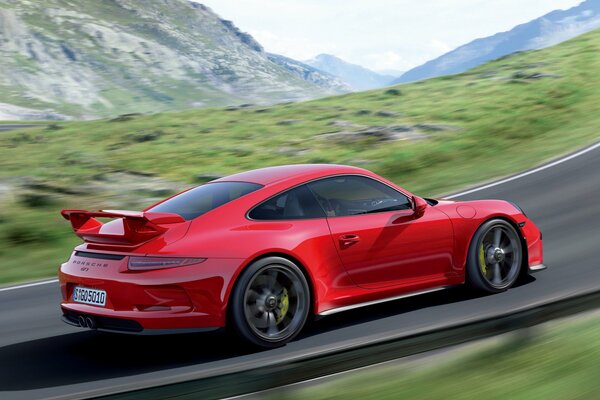 A red Porsche 911 gt3 that drives on the road