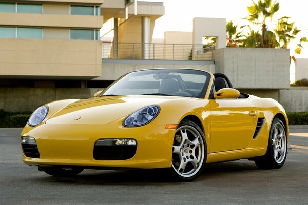 Yellow convertible on the background of the house