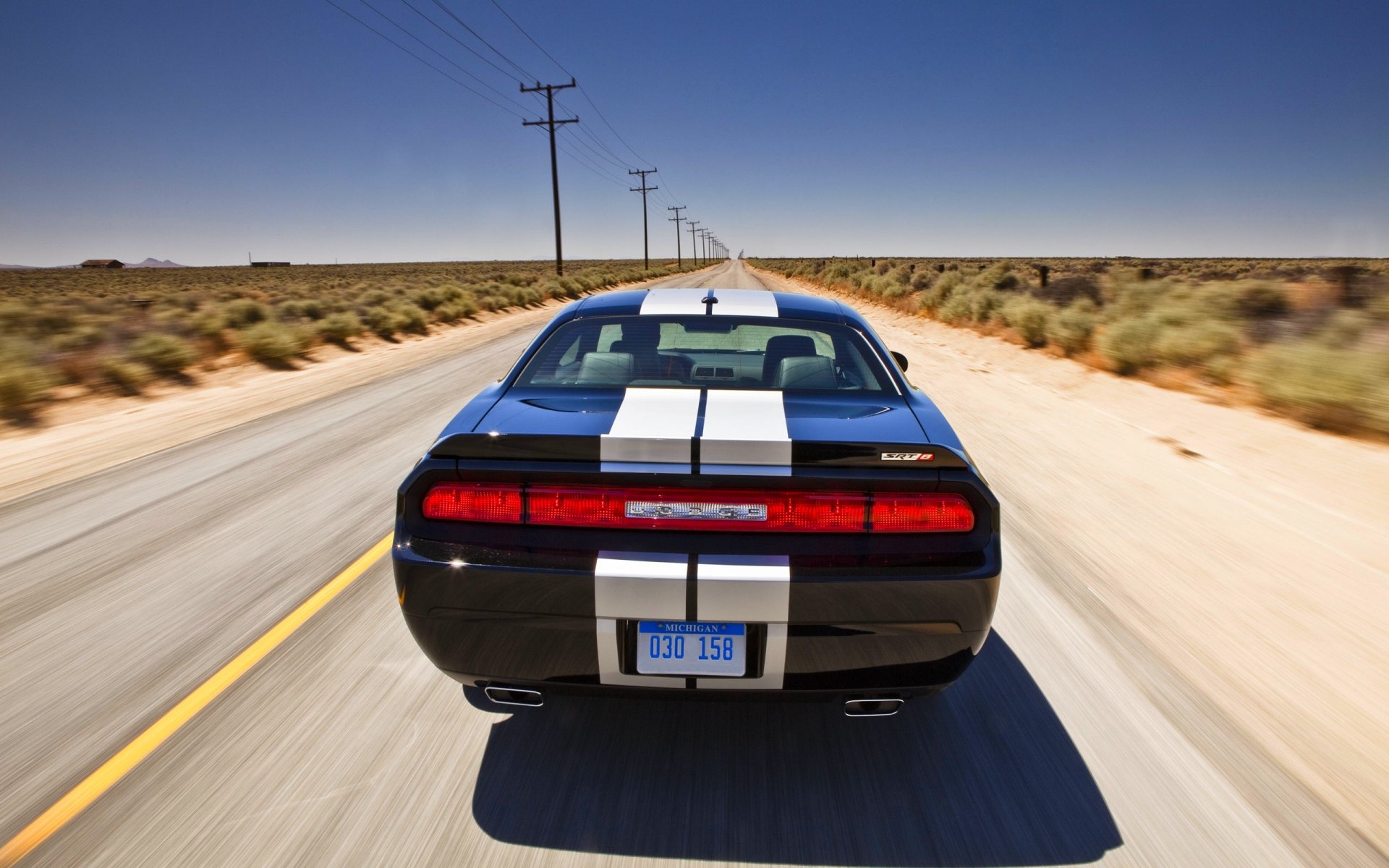 dodge challenger machine black in motion road sky day of the strip