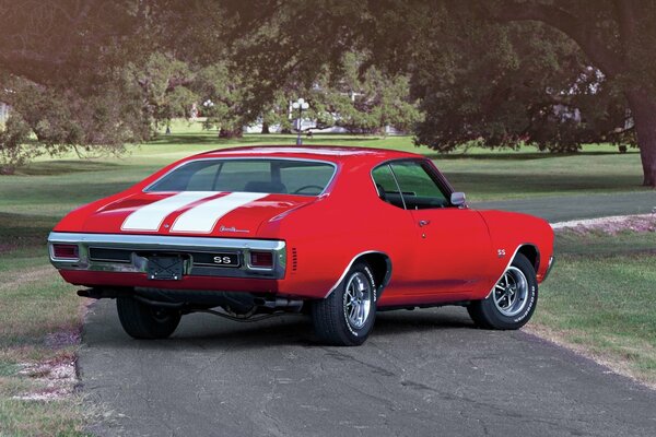 Voiture Chevrolet Chevelle rouge avec des rayures blanches sur le capot