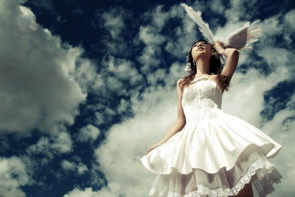 The bride in a white dress and wings