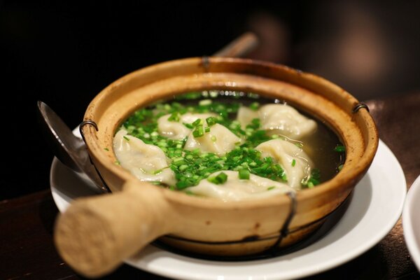 Beautifully served dumplings with bright greens