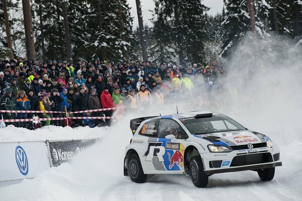 Volkswagen polo in the snow, with the crowd behind