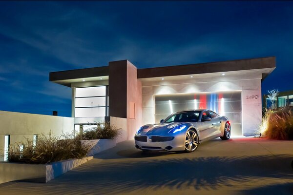 A white car in the dark against the background of a garage