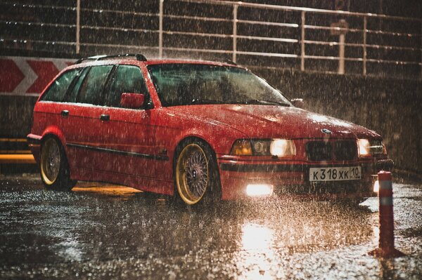 Red BMW car in the rain