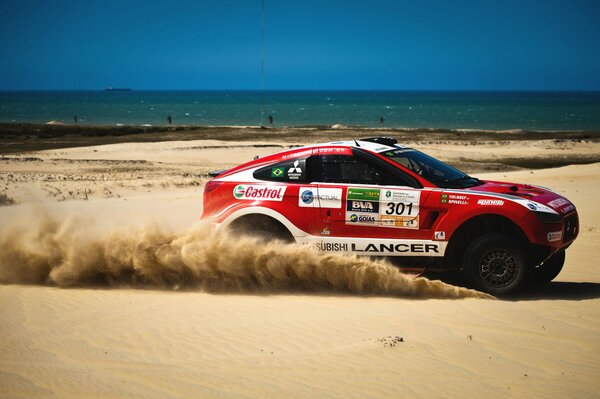 Red SUV on a sand background