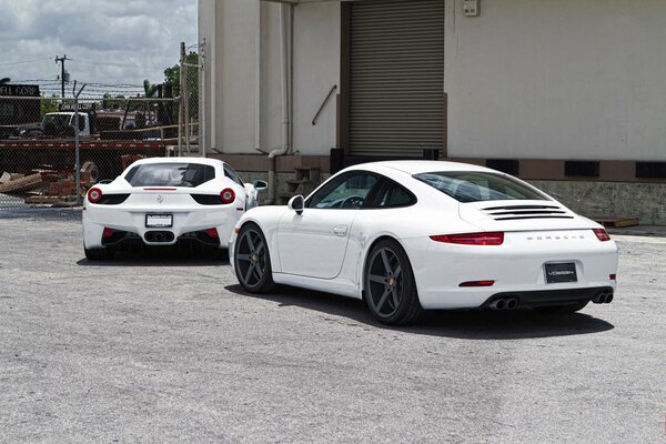 Porsche white, Ferrari photo near the garage of Italy