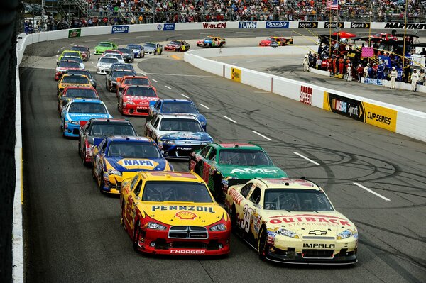 Cars participate in the race the stands are filled