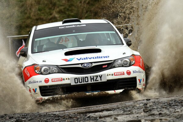 Subaru Impreza white rides on dirt