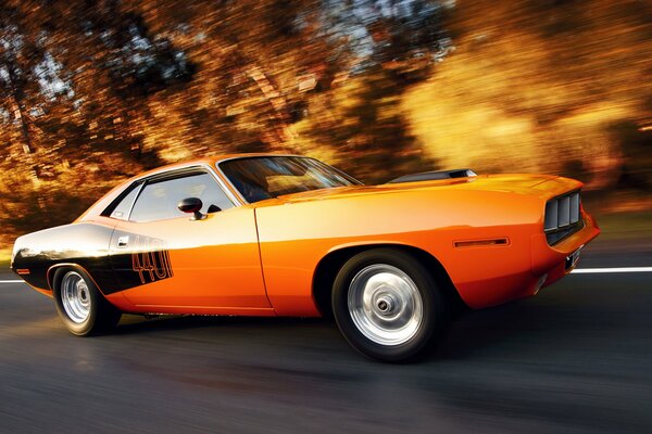 Une vieille voiture orange et noire en mouvement