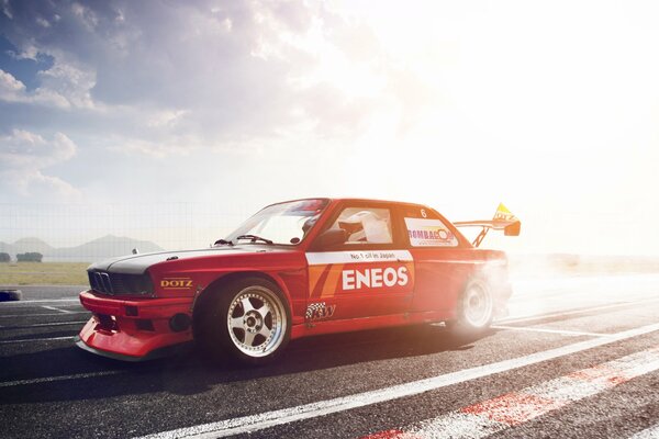 Auto wallpaper with tuned BMW e 30 third series in motion