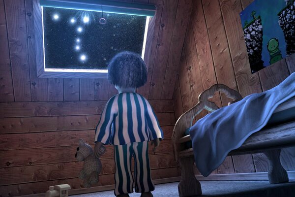 Ragazzo con un orso che guarda le stelle nella finestra