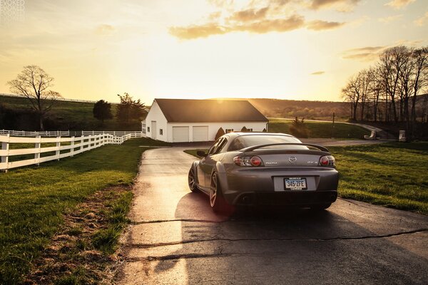 Grey mazda rx -8 on the road to home