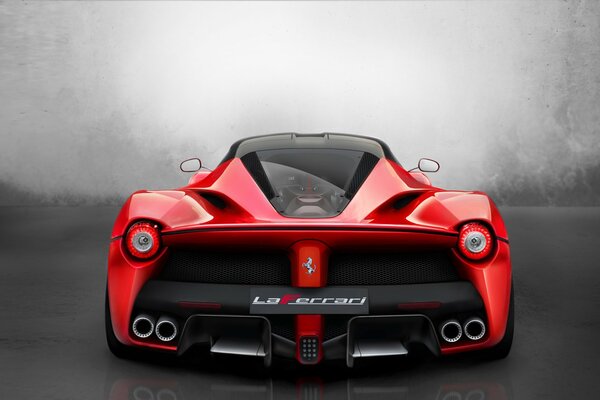 Red Ferrari supercar on a gray background