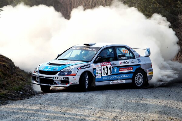 Skidding of a racing car with smoke in the back