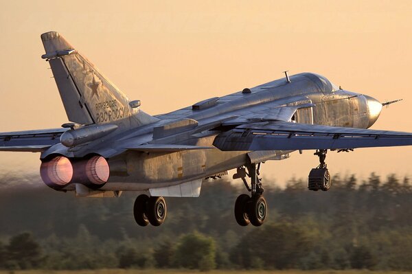 SU-24m bomber takeoff at sunset