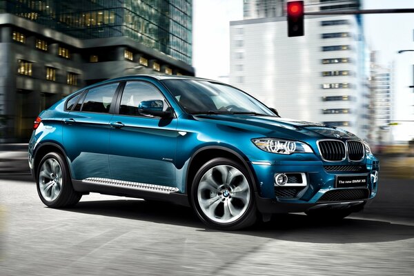 Auto wallpaper with a blue BMW x 6 car at a traffic light