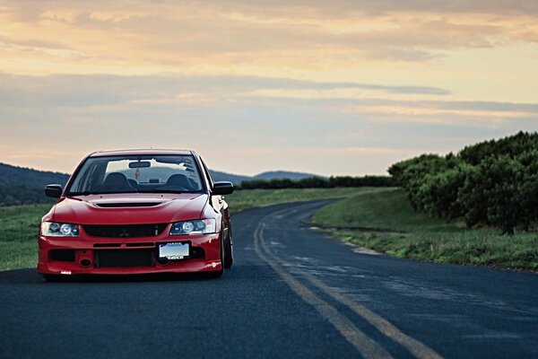 A tuned Mitsubishi is driving on the road