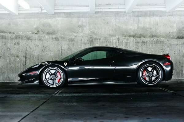 Black ferrari 458 on a wall background