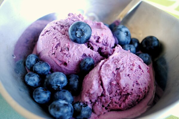 Beere-Eiscreme im violetten Farbton, bestreut mit Blaubeeren