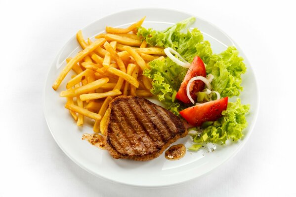 Delicious French fries with chop and lettuce leaves